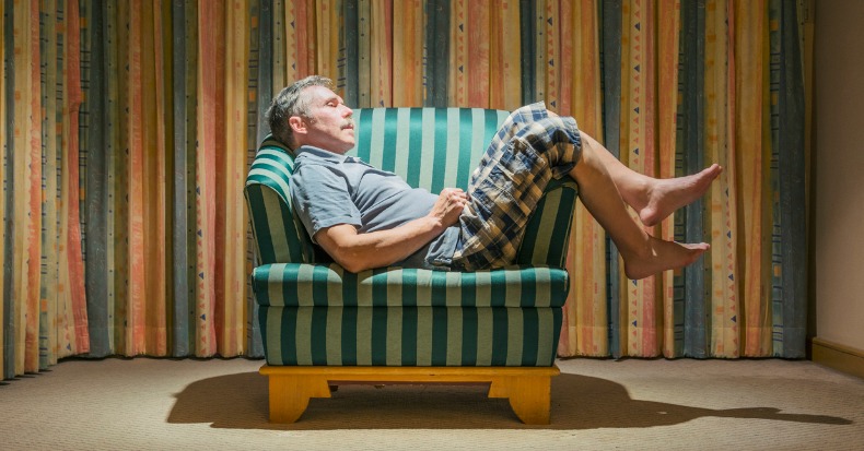 elderly man slouched and dozing off in a chair