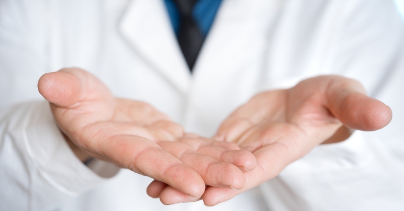 Healthcare professional with open hands symbolizing patient-centered care and support.