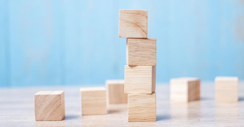 Stacked wooden blocks representing balance, stability, and structural support