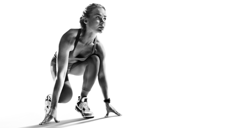 Athlete in a starting position illustrating movement, performance, and injury prevention.